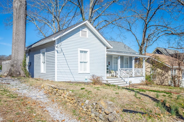 view of front of house with a porch and roof with shingles