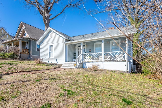 view of front of home featuring a porch and a front lawn