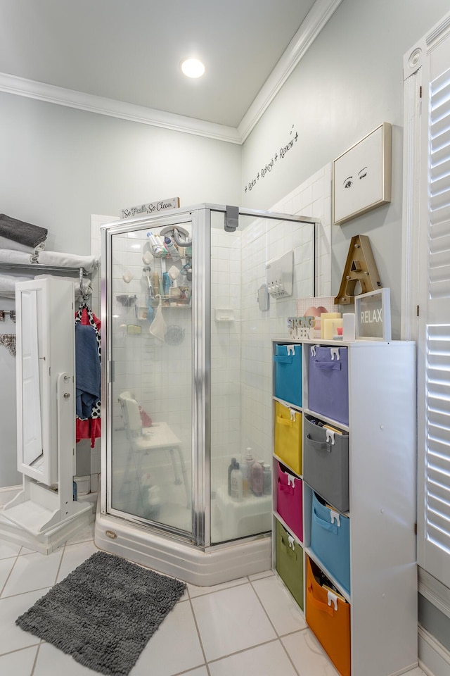 bathroom featuring a shower stall, tile patterned flooring, and crown molding