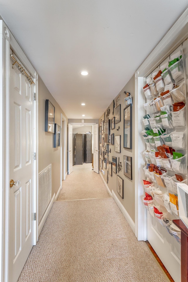 corridor with light carpet, recessed lighting, visible vents, and baseboards