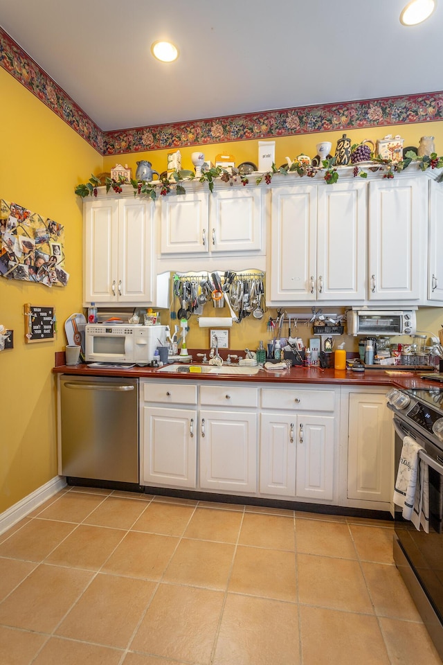 kitchen featuring white cabinetry, appliances with stainless steel finishes, and light tile patterned flooring