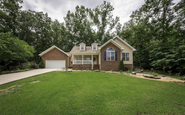 view of front of house with brick siding, concrete driveway, covered porch, a front yard, and a garage