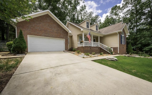 view of front of property featuring brick siding, concrete driveway, an attached garage, a porch, and a front yard