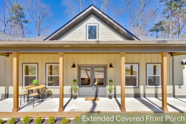 rear view of property featuring french doors, board and batten siding, and a shingled roof