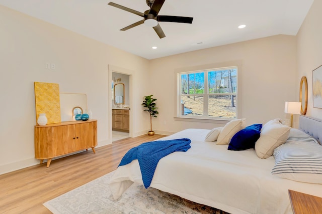 bedroom featuring light wood finished floors, recessed lighting, ensuite bath, and baseboards