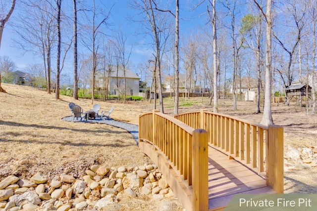 view of yard featuring an outdoor fire pit