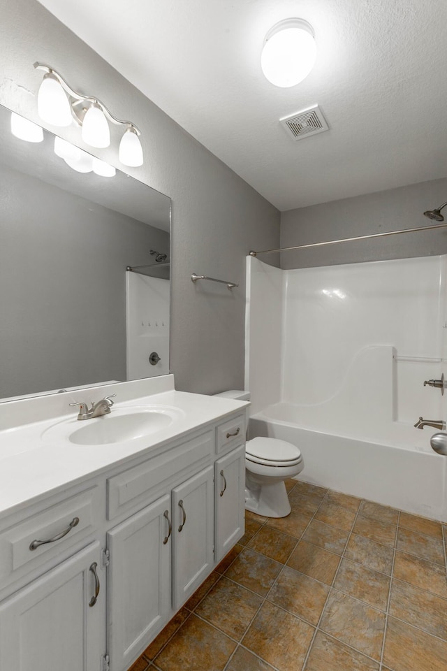 bathroom with visible vents, vanity, toilet, and bathing tub / shower combination