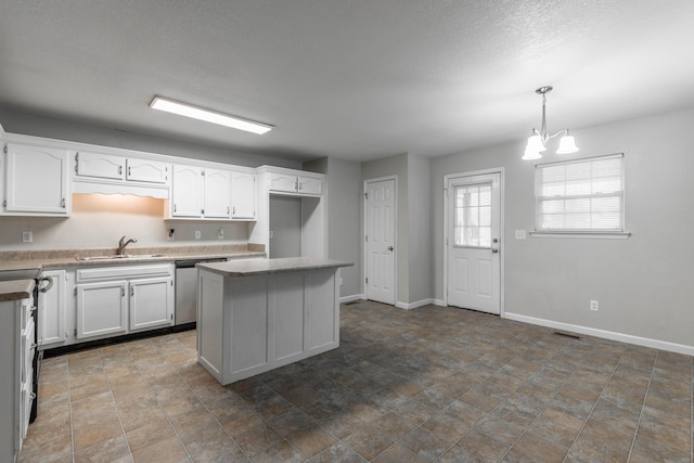 kitchen with stainless steel dishwasher, a sink, white cabinetry, and baseboards