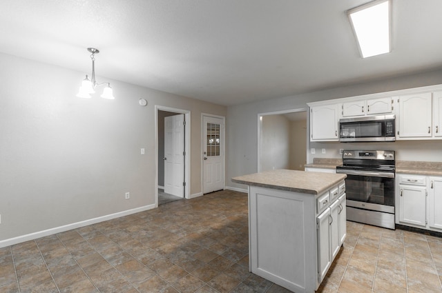 kitchen featuring white cabinetry, appliances with stainless steel finishes, light countertops, and a center island