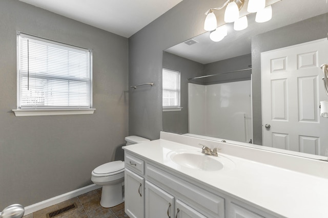 bathroom with toilet, vanity, visible vents, tile patterned floors, and walk in shower