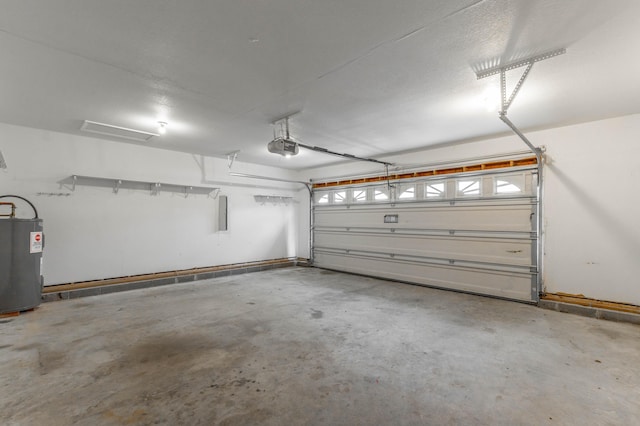 garage featuring a garage door opener and electric water heater