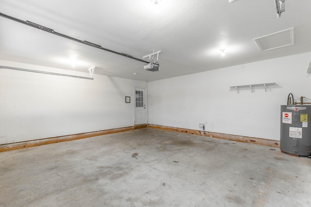 parking garage with water heater, baseboards, and a garage door opener