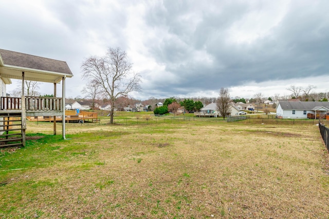 view of yard with a wooden deck and fence