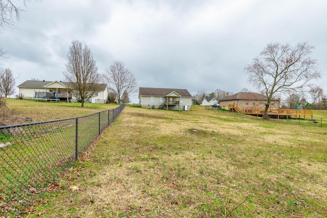 view of yard with fence and a deck