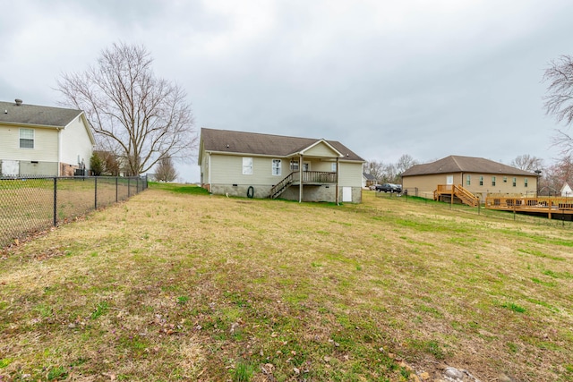 rear view of property with stairs, crawl space, a fenced backyard, and a lawn