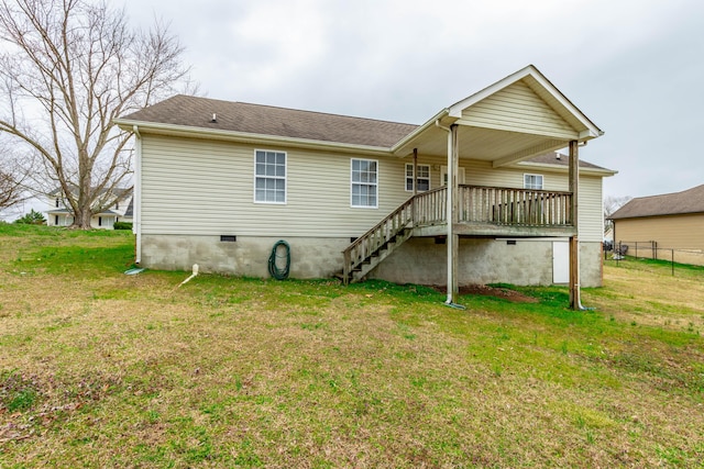 back of property with crawl space, a yard, fence, and stairs