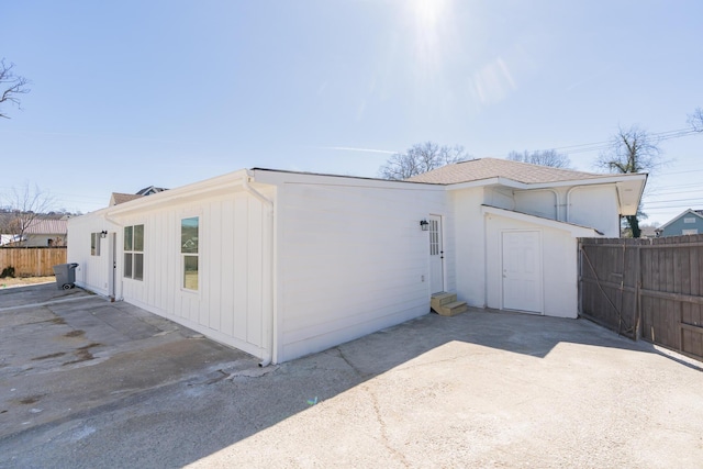 view of side of property featuring entry steps, a patio area, and fence