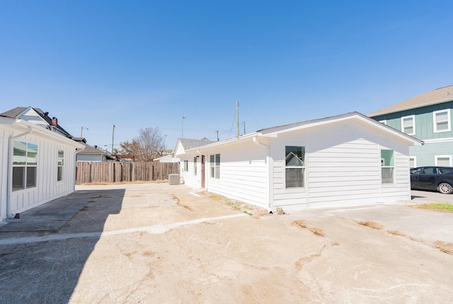 view of home's exterior with fence and a patio