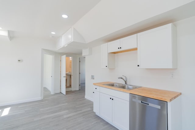 kitchen featuring stainless steel dishwasher, light wood-style floors, white cabinetry, a sink, and baseboards