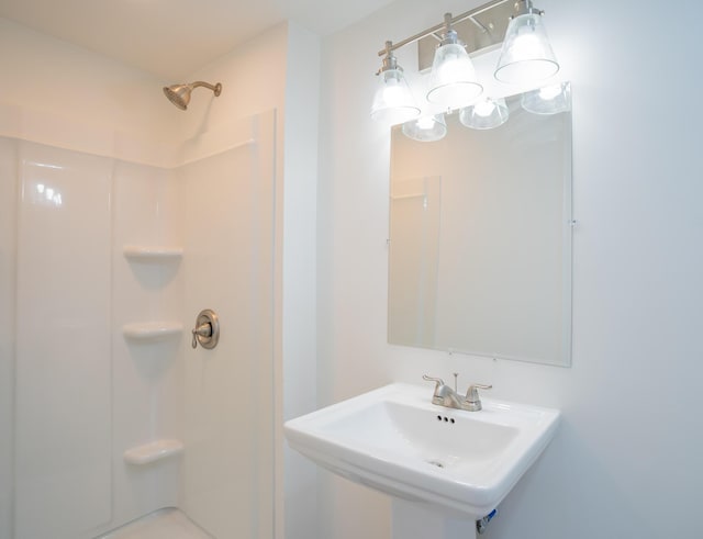 bathroom featuring a sink and walk in shower