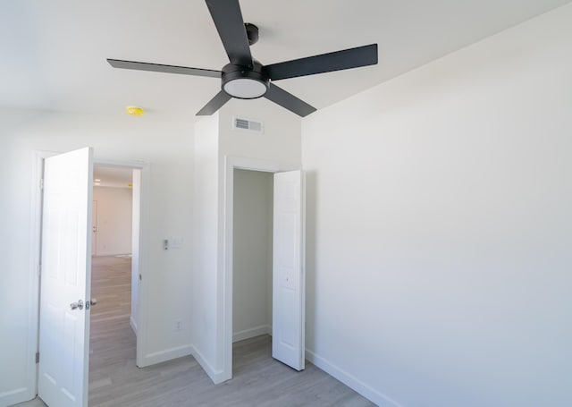 unfurnished bedroom with light wood-style floors, baseboards, and visible vents