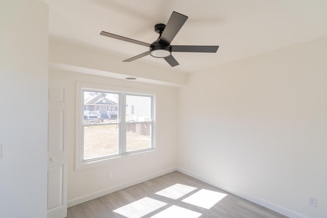 unfurnished room with ceiling fan, light wood-type flooring, and baseboards