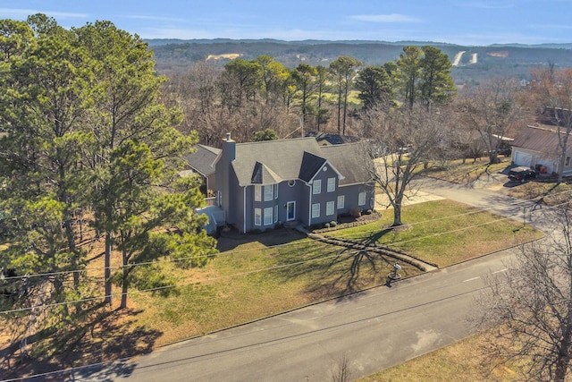 drone / aerial view featuring a wooded view