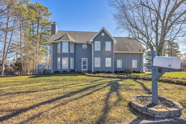 view of front of property featuring a shingled roof, a chimney, and a front yard