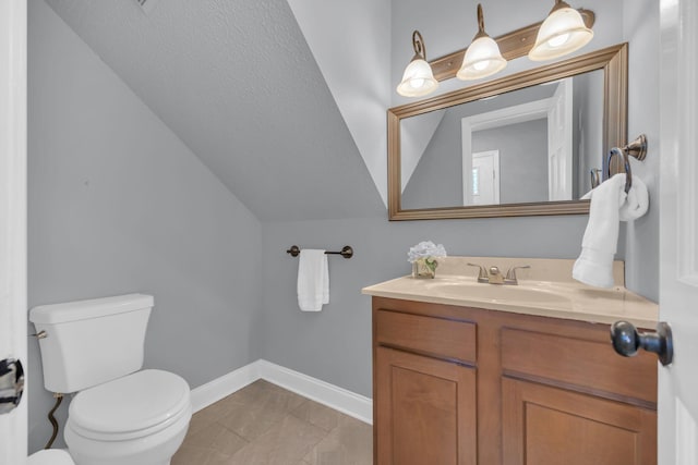 half bathroom with toilet, baseboards, vaulted ceiling, and vanity