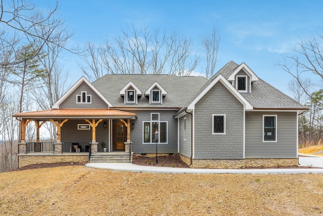 view of front facade with a porch and roof with shingles