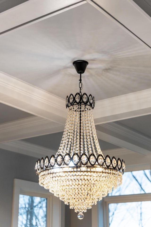 interior details featuring an inviting chandelier and crown molding