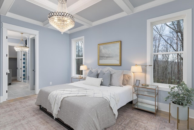 bedroom with beam ceiling, multiple windows, and an inviting chandelier