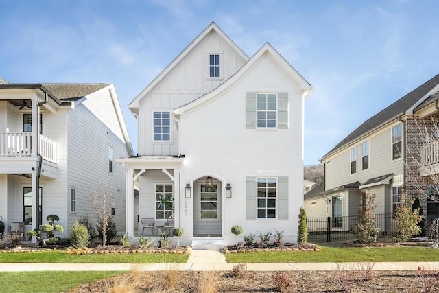 view of front facade with fence and board and batten siding