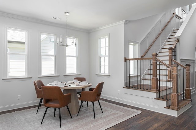 dining room with ornamental molding, visible vents, baseboards, and wood finished floors