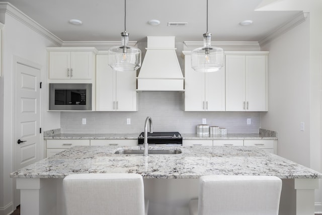 kitchen featuring stainless steel microwave, ornamental molding, a sink, custom exhaust hood, and backsplash