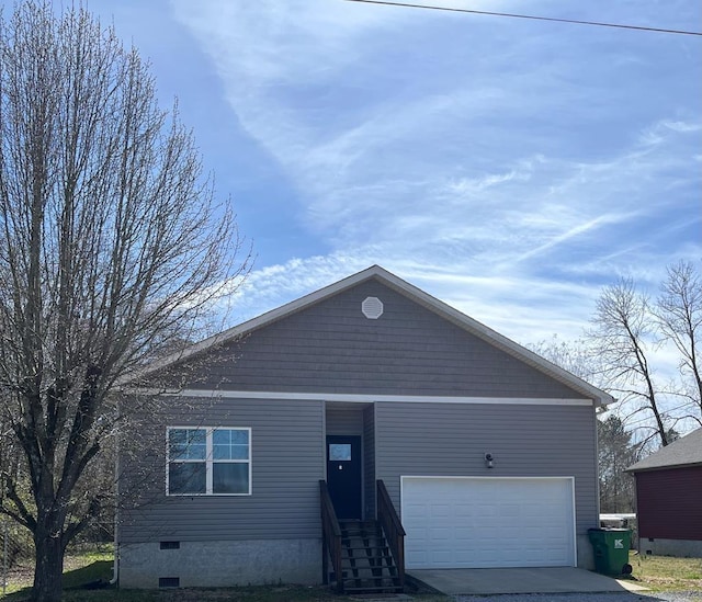 single story home featuring crawl space, an attached garage, and concrete driveway