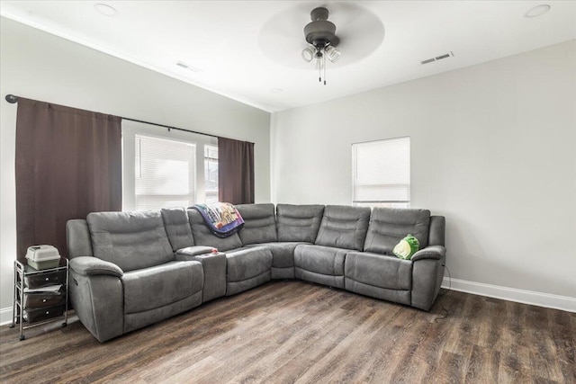 living area with ceiling fan, visible vents, baseboards, and wood finished floors