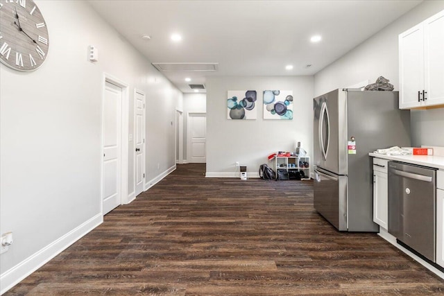 kitchen with dark wood-type flooring, baseboards, recessed lighting, stainless steel appliances, and white cabinetry