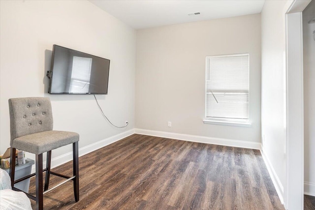 unfurnished room with visible vents, dark wood-type flooring, and baseboards