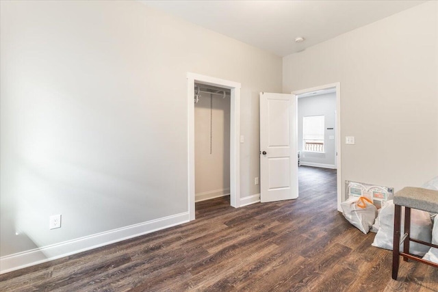 interior space featuring baseboards and dark wood-style flooring