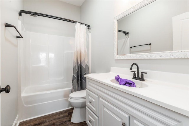 full bath featuring shower / bathtub combination with curtain, toilet, vanity, and wood finished floors