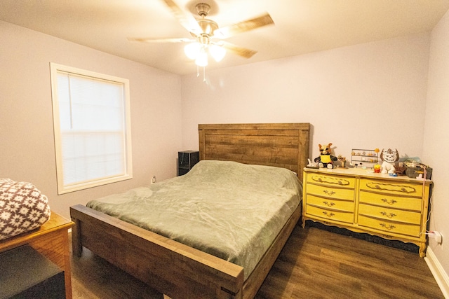 bedroom with a ceiling fan and dark wood-type flooring