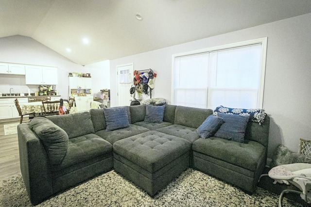 living room with lofted ceiling and light wood-style floors