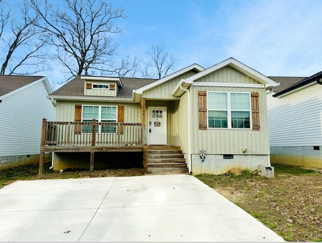 view of front facade with a shingled roof, crawl space, a porch, and board and batten siding