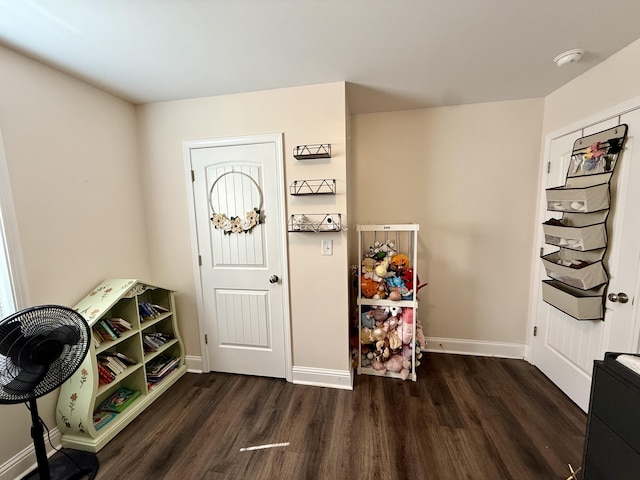 entryway with wood finished floors and baseboards