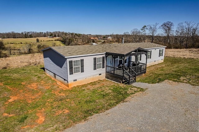 manufactured / mobile home with crawl space, driveway, a front lawn, and roof with shingles