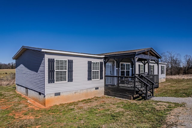 manufactured / mobile home with a gazebo, crawl space, a front yard, and a wooden deck