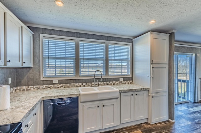 kitchen with black appliances, a wealth of natural light, a sink, and dark wood finished floors