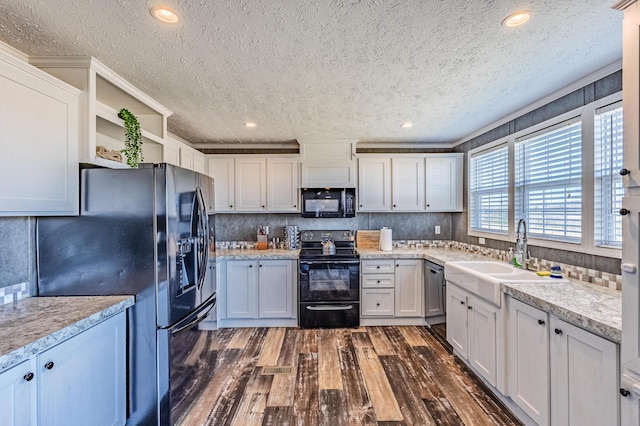 kitchen with dark wood-style floors, open shelves, light countertops, a sink, and black appliances