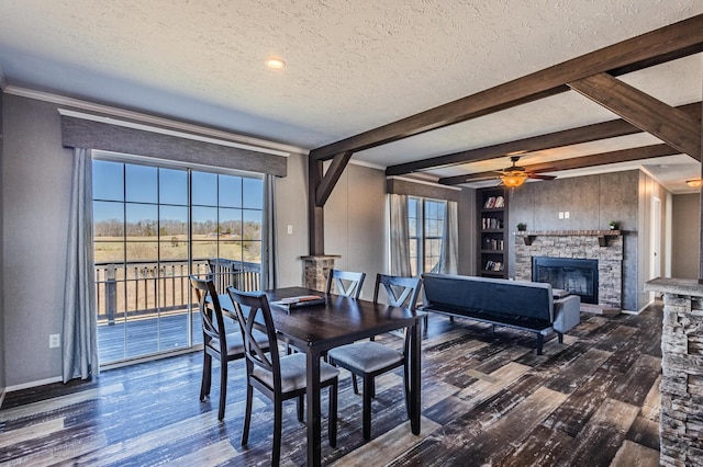 dining space with a textured ceiling, plenty of natural light, and wood finished floors